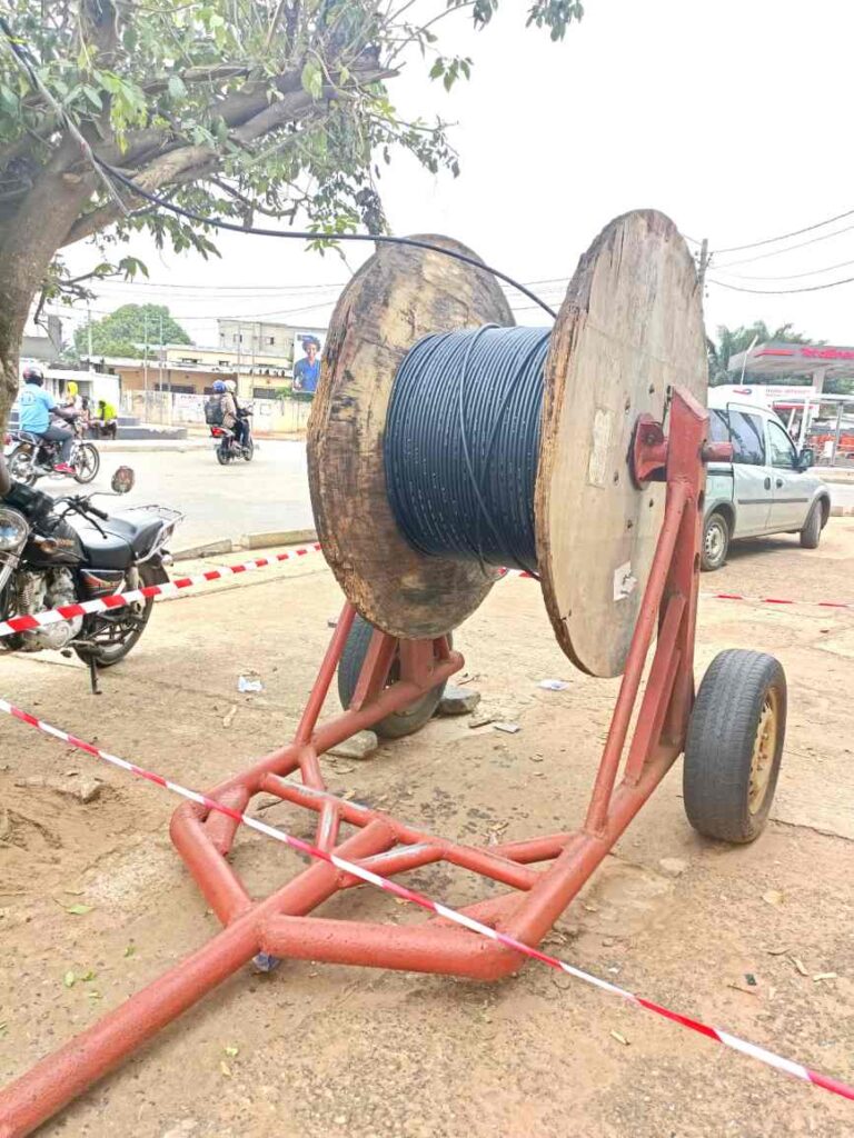 ADSS fiber optic cable drum on a trailer for aerial installation in an African urban area.