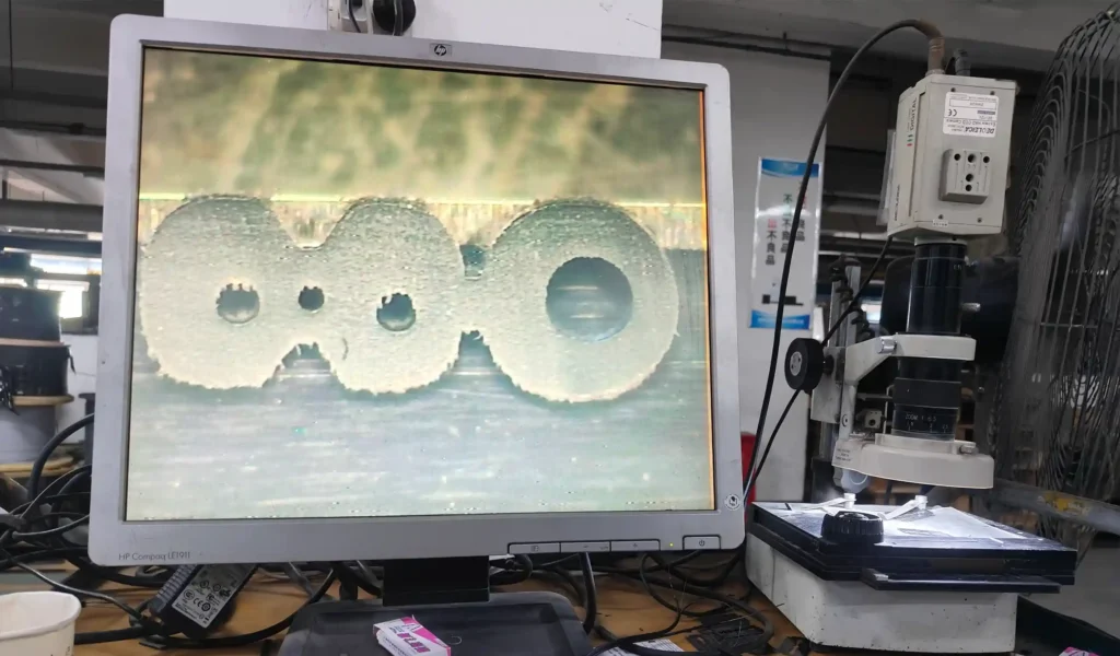 Microscopic inspection of FTTH drop cable cross-section at HiFTTH laboratory.